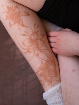 Henna Mehndi Temporary Tattoo Flowers on Leg. Close up.