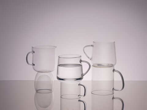Elegant clear glass mugs are arranged in a minimalist still life