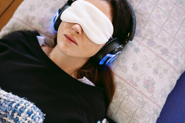 Woman relaxing with sleep mask and headphones