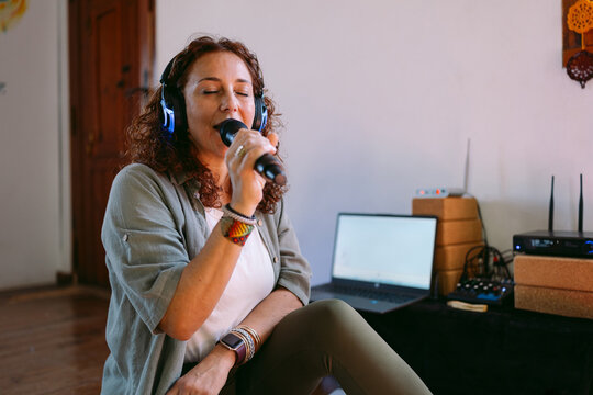 Singer practicing vocal exercises with microphone