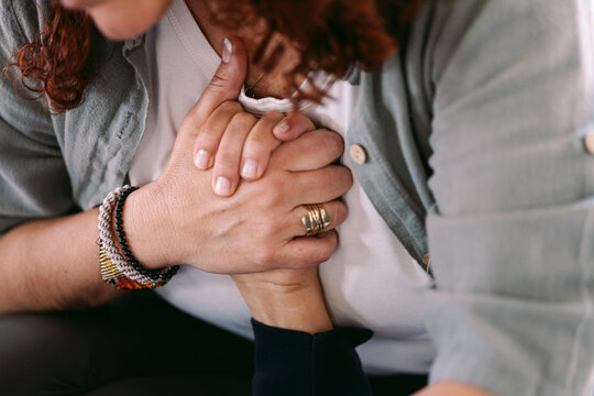 Woman breathing deeply and touching chest during meditation session