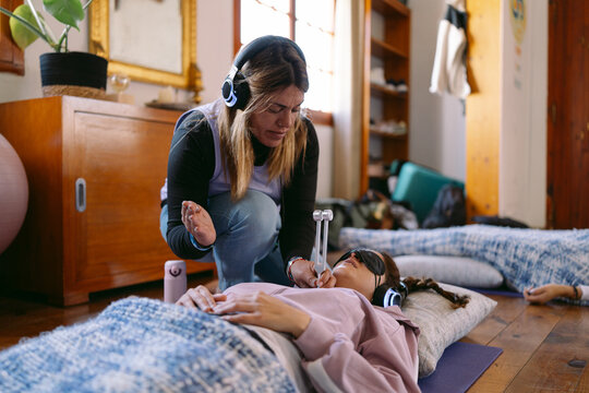 Therapist using tuning fork during sound healing therapy session