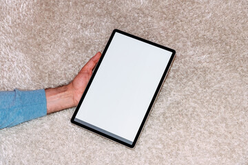 Person holding modern tablet with blank screen. Mock-up. 