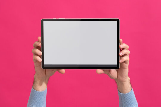 Person holding modern tablet with blank screen. Mock-up. 