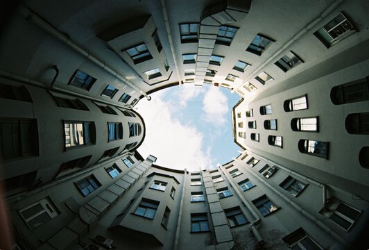 View of Buildings from Courtyard with Sky Above
