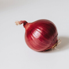 Single red onion isolated on white background