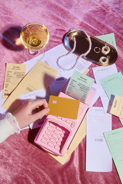Credit Card Payment with Receipts on Pink Table