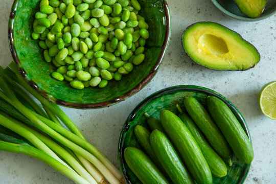 Fresh green produce, including cucumber and avocado.