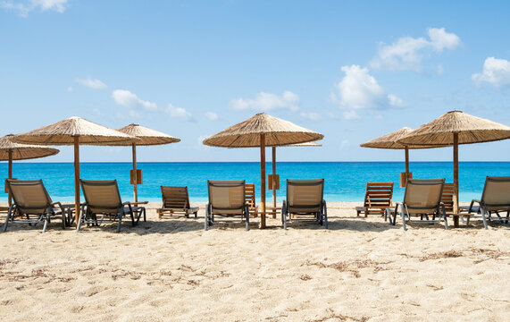 Empty beach chairs and umbrellas on a tropical beach