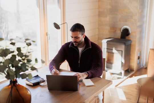 Man Working at Home in a Comfortable and Bright Modern Setting