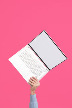 Person holding modern laptop with blank screen. Mock-up. 