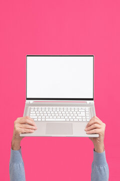 Person holding modern laptop with blank screen. Mock-up. 