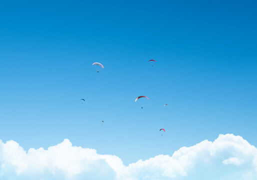 Dreamlike paragliding on sunny day