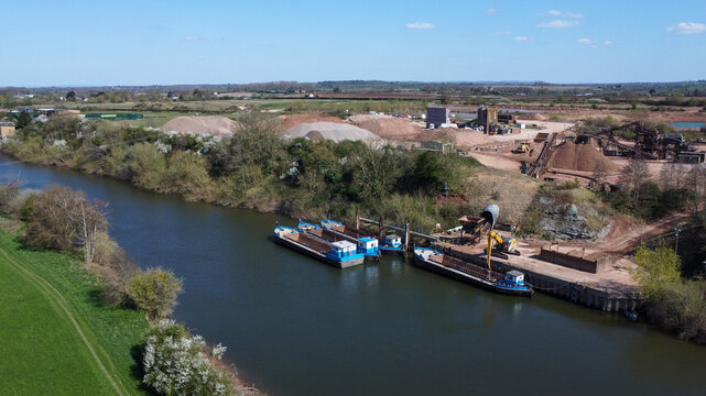Empty river barges next to a aggregate processing site