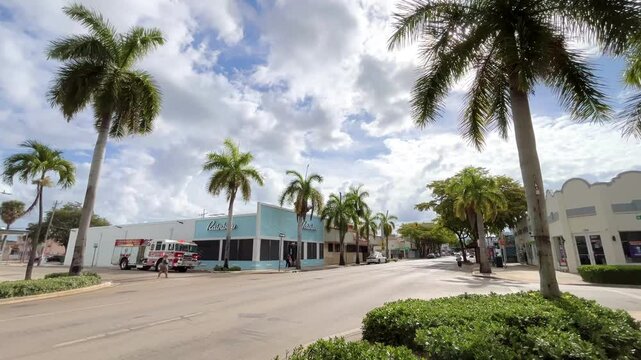 Little Havana's Calle Ocho showing vibrant street scene with palm trees under partly cloudy sky in Miami, Florida