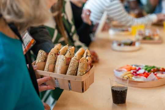 Wooden basket of assorted sandwiches at a group catering gathering