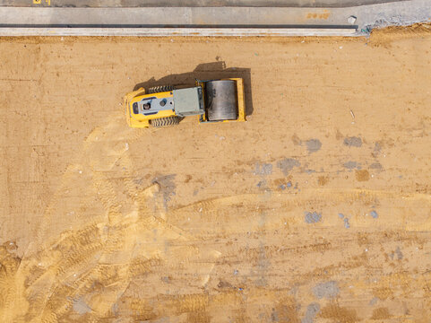 Aerial View of Road Roller Compacting Road Surface