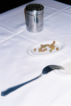 plate with some olive pits on a table, 35mm