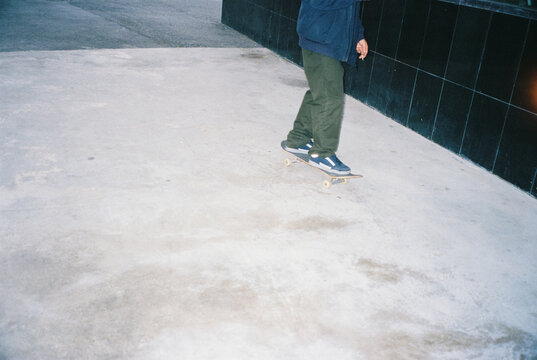 unknown young man riding a skateboard, 35mm