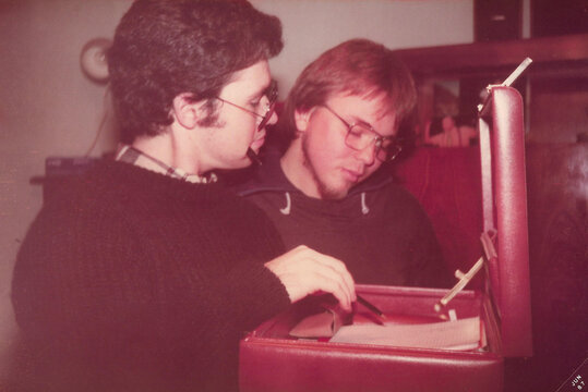Two friends pretending to be office workers in 1980s style