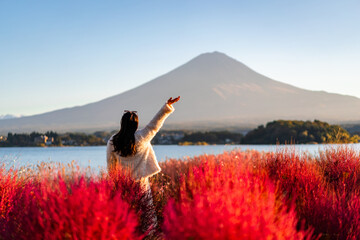 Young female tourist relaxing and enjoying at beautiful landscape mount Fuji at Kawaguchiko Lake