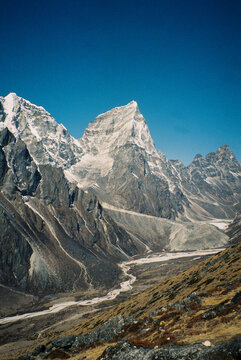 Snow-capped peaks of the Himalayas under clear blue skies
