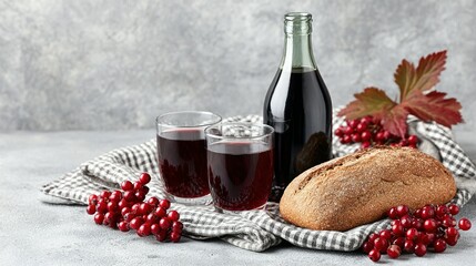 Dark red beverage, bread, and berries on a grey surface.