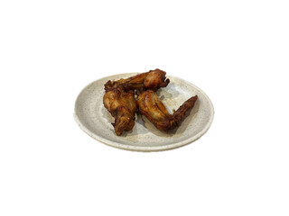Chicken wings processed into food, often fried and served with spices or sauce.
