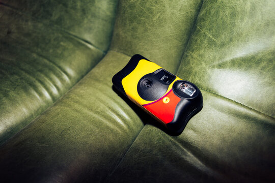 Disposable camera on green leather sofa