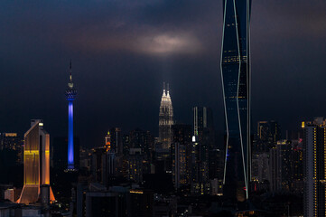 Moody skyline at night with glowing tower lights