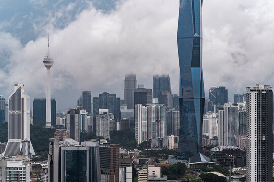 Urban skyline emerging from clouds after heavy rainfall