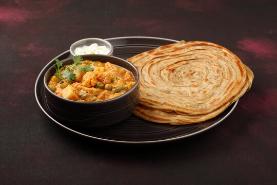 Malabar parotta with Kurma is a delicacy from the state of Kerala, Tamilnadu. Kurma is mixed veg south Indian curry with coconut milk