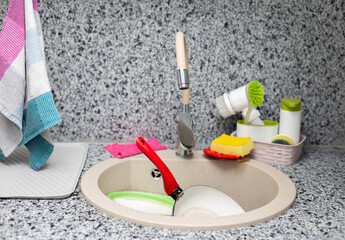 modern kitchen sink with a mountain of dirty dishes