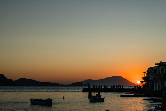 Stunning sunset over the town of Klima in Milos coastline in Greece