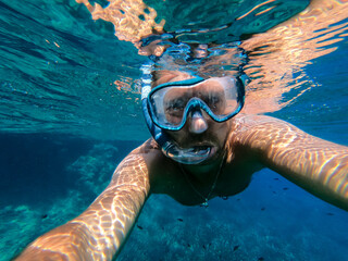 Man snorkeling in the sea in summer