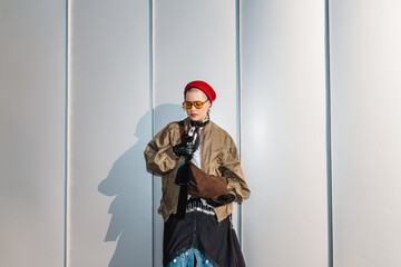 Stylish person in red sailor-style hat holding a bag