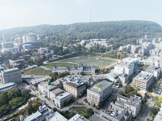 Fototapeta premium Drone flight in the downtown city skyline, foggy daytime view of Montreal, Quebec, Canada
