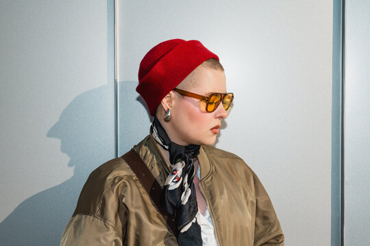 Stylish person wearing red hat and sunglasses