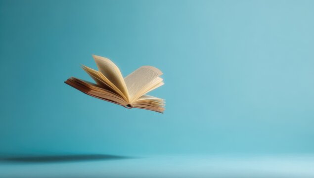 Open book floating in air against a light blue background