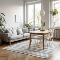 Light-filled living space with grey sofa, striped rug, wooden dining table and chairs, and potted plants