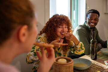 Friends enjoying a meal together at home