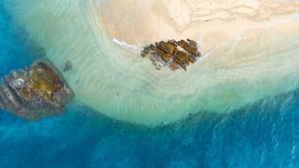 Nature of the beach and sea Summer with sunshine, sandy beaches, clear blue waters sparkling against the blue sky. On an island with good ecology and environment Background for summer vacation