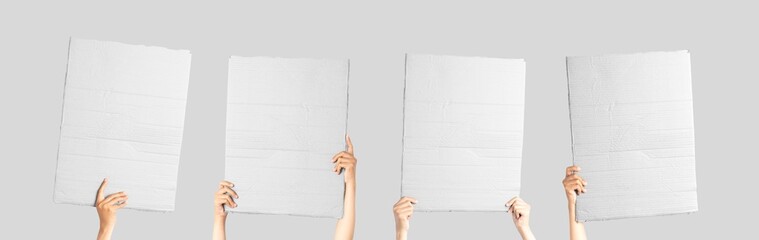 Multiple posters from white cardboard in his hand. Isolated on white. Set. Copy space. Handheld cardboard cutout on white background.