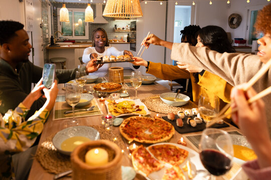 Dinner gathering with friends enjoying diverse cuisine
