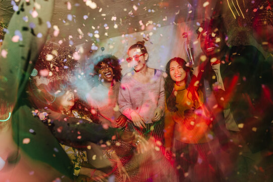 Joyful celebration with friends and confetti explosion