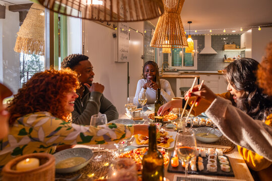 Friends enjoying dinner at a cozy kitchen table