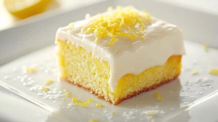 Lemon Cake Slice with Creamy Frosting and Zest Garnish