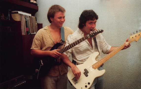 Young men rehearsing with guitars