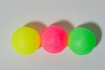 Three Colorful Spheres On White Surface