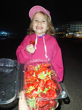 happy kid eating strawberry